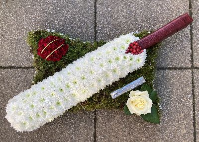 Cricket bat and ball on a green