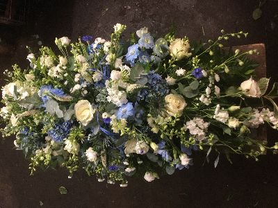 White and blue casket spray