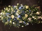 White and blue casket spray